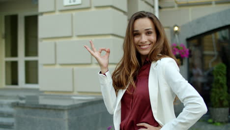 portrait of positive business woman looking at camera outdoors