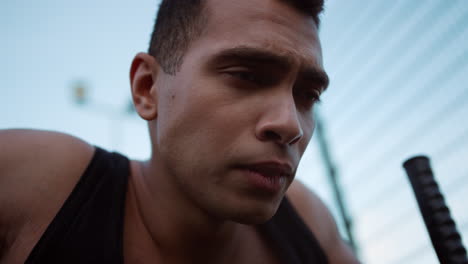 closeup exhausted mixed race sportsman training alone in sport playground.