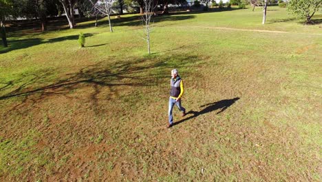 Man-walking-in-park-during-autumn