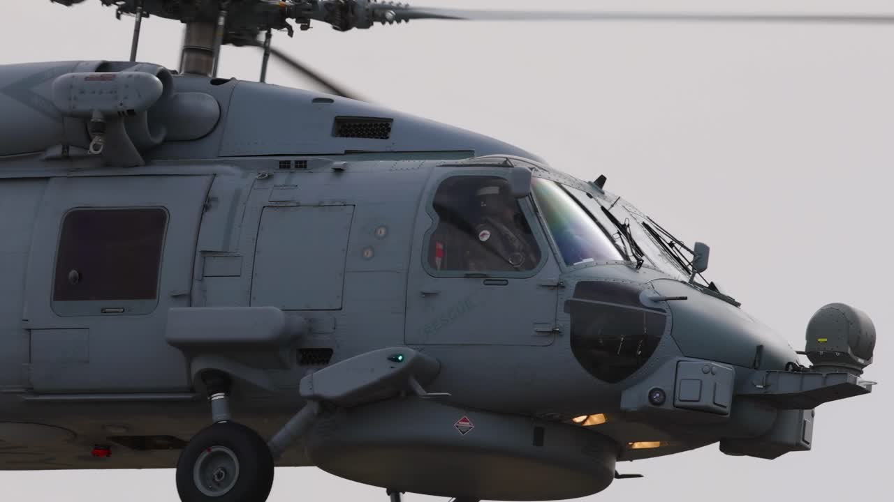 A military helicopter flies steadily against a clear sky, showcasing its design and functionality at the Avalon Airshow in Geelong