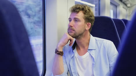 man looking out the train window