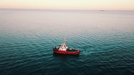 drone flying over the fishing boat sailing on the baltic sea at the sunset