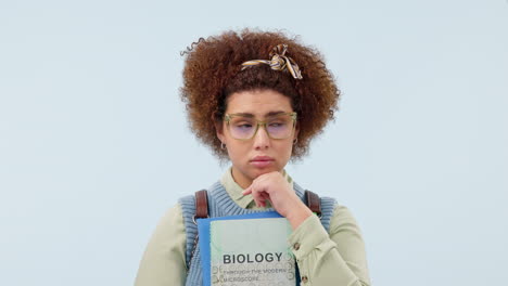 student, nervous and think in studio on blue