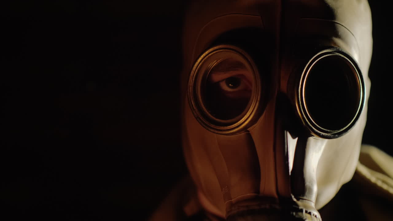 The Gleams Of The Fire Are Reflected In The Eye And Gas Mask Of The Man