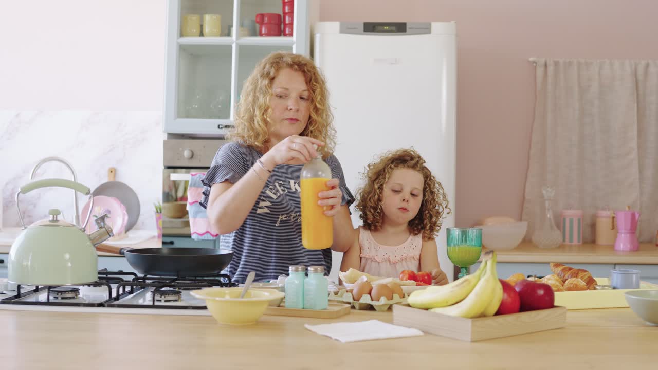 Mother and daughter preparing breakfast