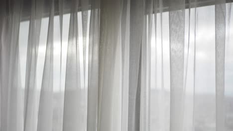 white sheer curtains at a window