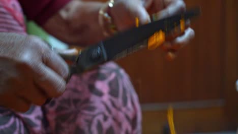 Woman-Using-A-Scissor-To-Cut-Off-The-Flower-Head-Of-Marigolds-In-Agra,-India---Closeup-Shot