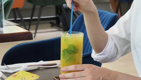 woman enjoying a mojito at a restaurant