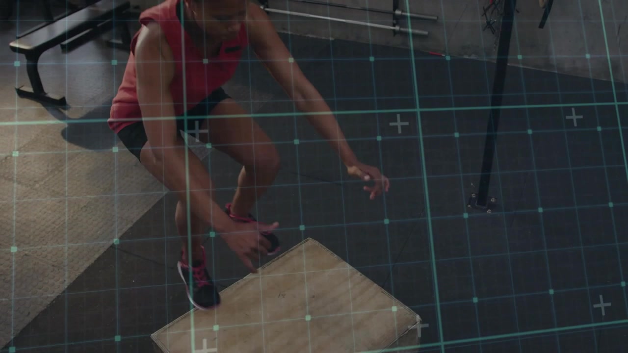Mid-adult woman squatting and swinging arms, launching box jumps for fitness, blue grid overlaying