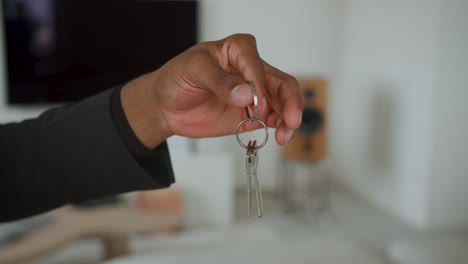 Man-holding-house-keys