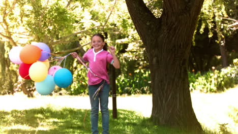 child jumping in slow motion with balloons