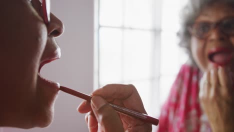 a senior african american woman spending time at home taking care of herself  in social distancing