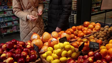couple shopping for fruits at a grocery store