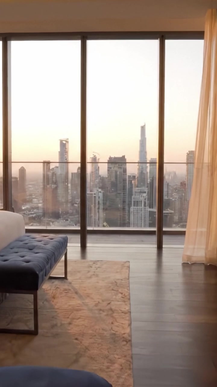Serene Cityscape: A Breathtaking View from a Luxurious High-Rise Apartment Overlooking a Vibrant Skyline at Sunset, Capturing the Beauty of Urban Living.