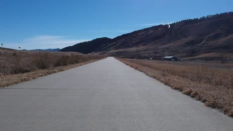 a drone pull back shot along a bike path