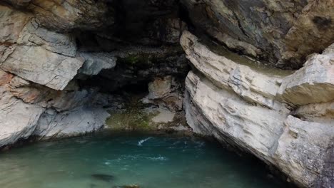 a drone shot of water flowing down rocks below it