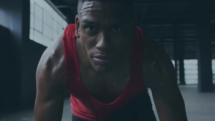 Animation of blue trails over african american sportsman at gym