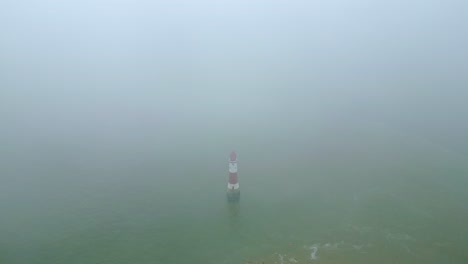 beachy head lighthouse revealing shot - top down dive close up view from white cliffs taken by dji mini 3 pro drone in eastbourne england