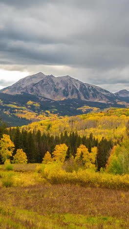 Vertical-4k-Timelapse,-Clouds-Moving-Above-Yellow-Aspen-Forest-and-Mountain-Peak