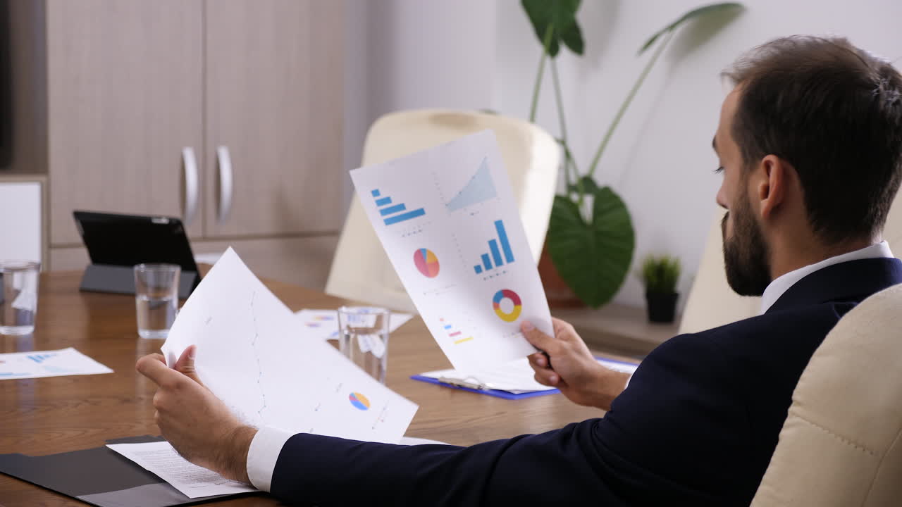 Businessman analyzing charts and graphs in a conference room