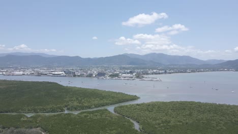 aerial view of lush green landscape and hills creek at trinity forest reserve in trinity near cairns, north queensland, australia