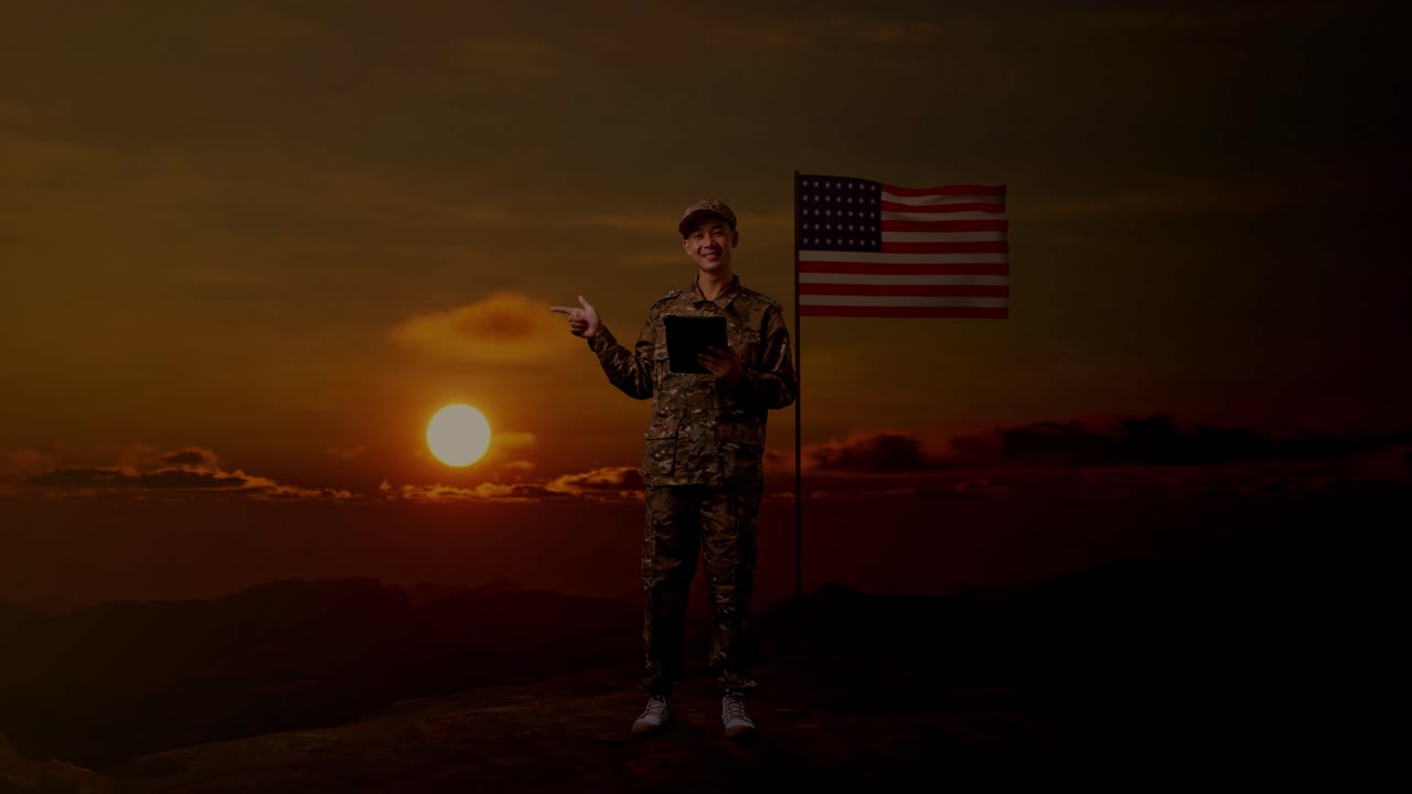 Full Body Of Asian Man Soldier Using A Tablet And Pointing To Side While Standing With Flag Of The United States, Sunset Time