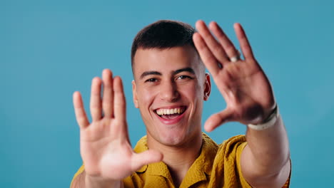 portrait of a smiling man posing with his hands