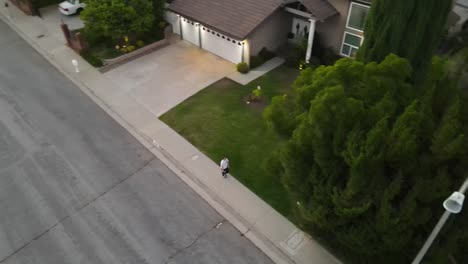 Person-walking-down-street-aerial