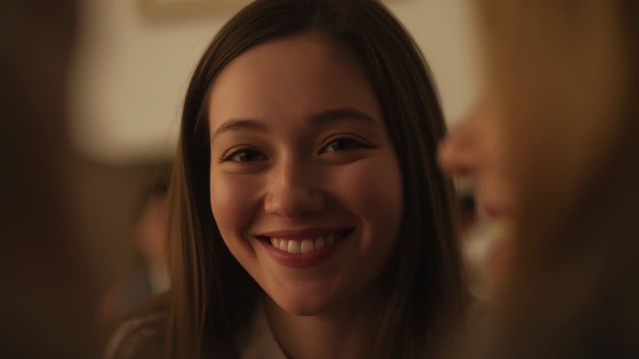 Listening Asian woman in light shirt shifting to smile while friend speaking in lounge, artwork