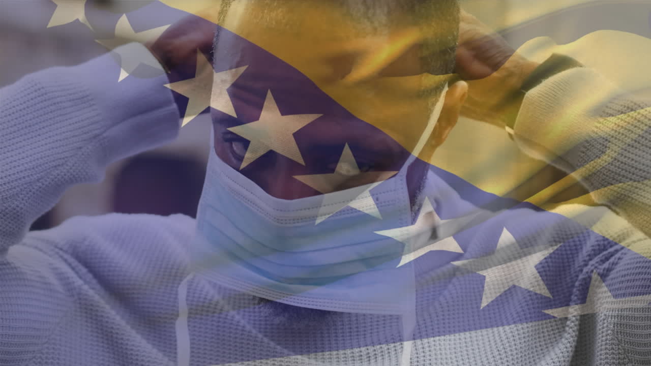 보스니아 헤르체고비나에서 길거리에서 얼굴 마스크를 쓰고 있는 아프리카계 미국인 남자를 향해 흔들리는 애니메이션