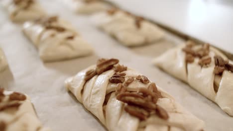 unbaked pecan pastries on a baking sheet