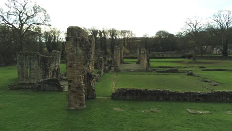 Basingwerk-abbey-landmark-medieval-abandoned-Welsh-ruins-Aerial-view-low-slow-orbit-right-shot