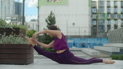 woman doing splits in urban park
