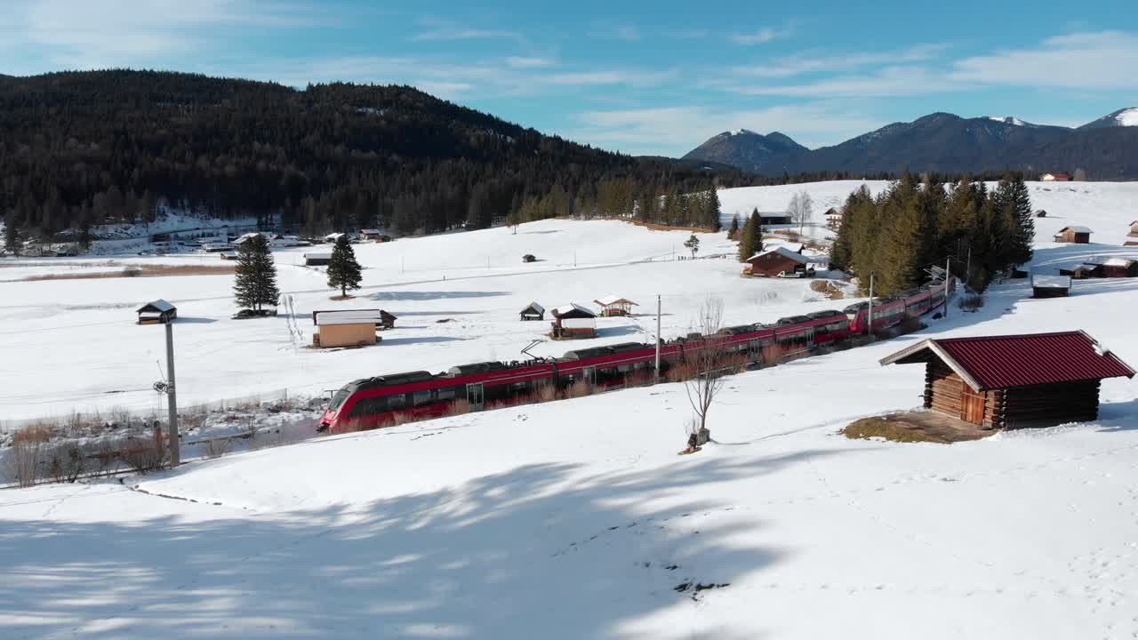Aerial: train near Mittenwald emerging among trees