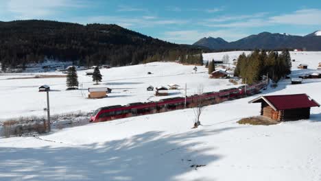 aerial: train near mittenwald emerging among trees