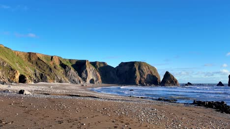 Winter-beach-incoming-tide-and-lapping-waves-on-beach-winter-morning-on-The-Copper-Coast-Waterford-Ireland