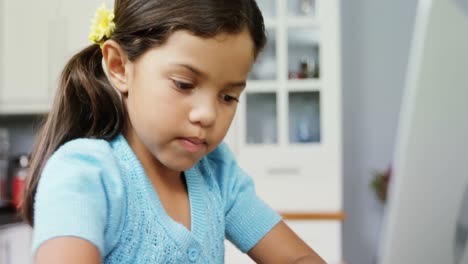 Girl-using-laptop-in-kitchen-4k