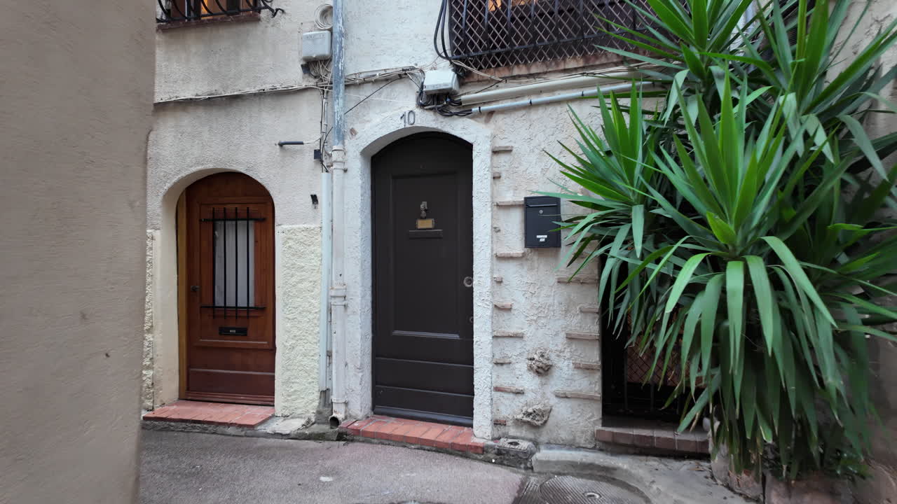 Antibes, France - July 14, 2025: Narrow streets between buildings in the city on a cloudy day