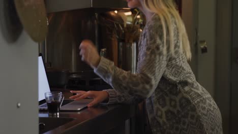 Caucasian-woman-concentrated-and-working-in-her-house