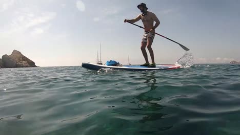 Man-paddle-surfing-on-a-beach-in-the-south-of-Spain,-Almeria