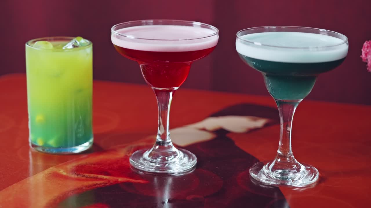 Close up pan shot of four different drinks representing global power centers