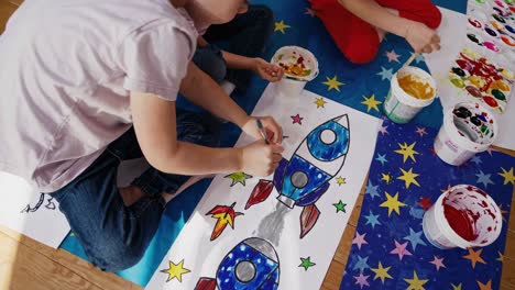 children painting rockets