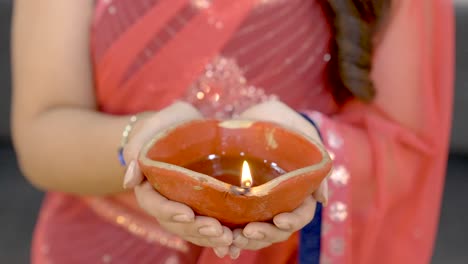 indian woman holding diya