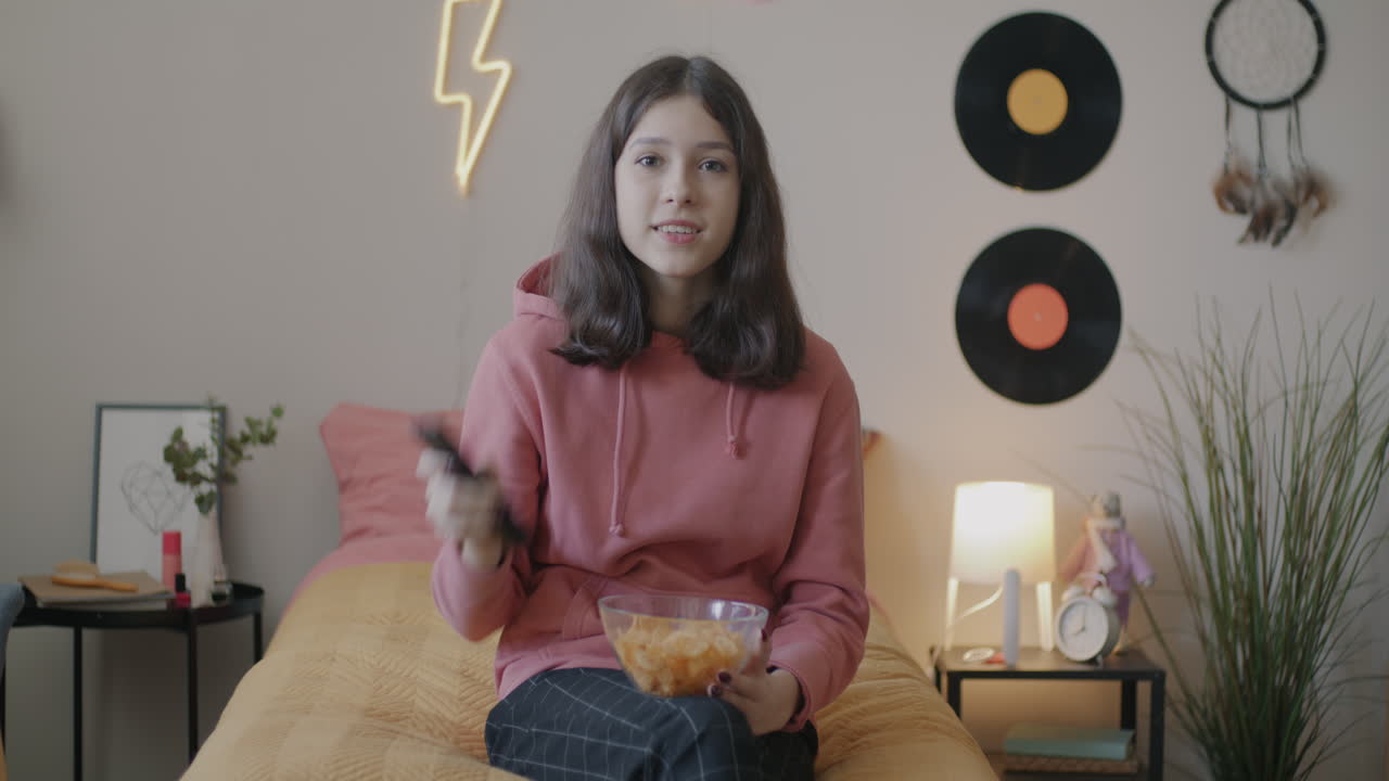 Teenage Girl Eating Snacks in Her Bedroom