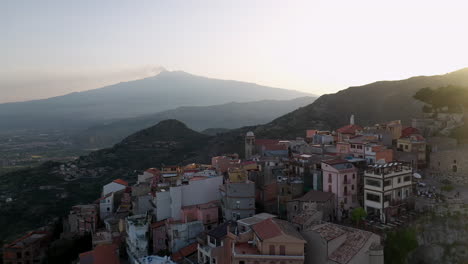 revealing drone shot of castelmola homes and buildings built on a natural terrace in sicily italy