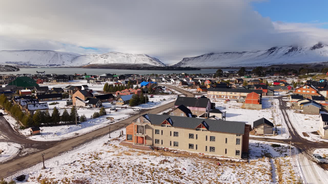 Peaceful suburban homes covered in snow during winter in Caviahue, Neuquén, Argentina - mountains in backdrop