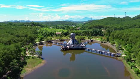 Aerial-view-of-Ho-Thuy-Tien-abandoned-water-park-with-huge-dragon-structure-and-empty-lake-in-Hue,-Vietnam