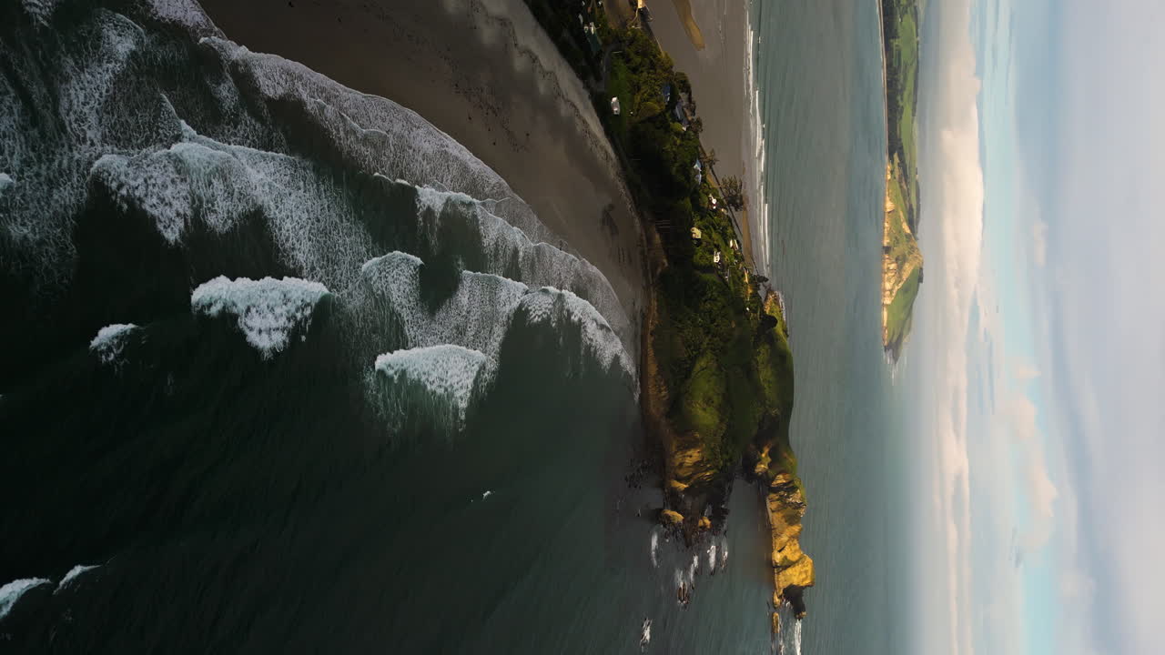 península de huriawa y playa de karitane, costa pacífica de la isla sur de nueva zelanda, vertical aérea
