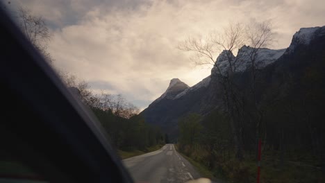 an electric vehicle driving in norwegian landscape