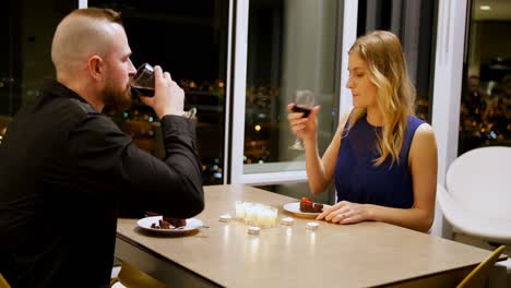 Couple-toasting-glass-of-wine-while-having-dinner-4k